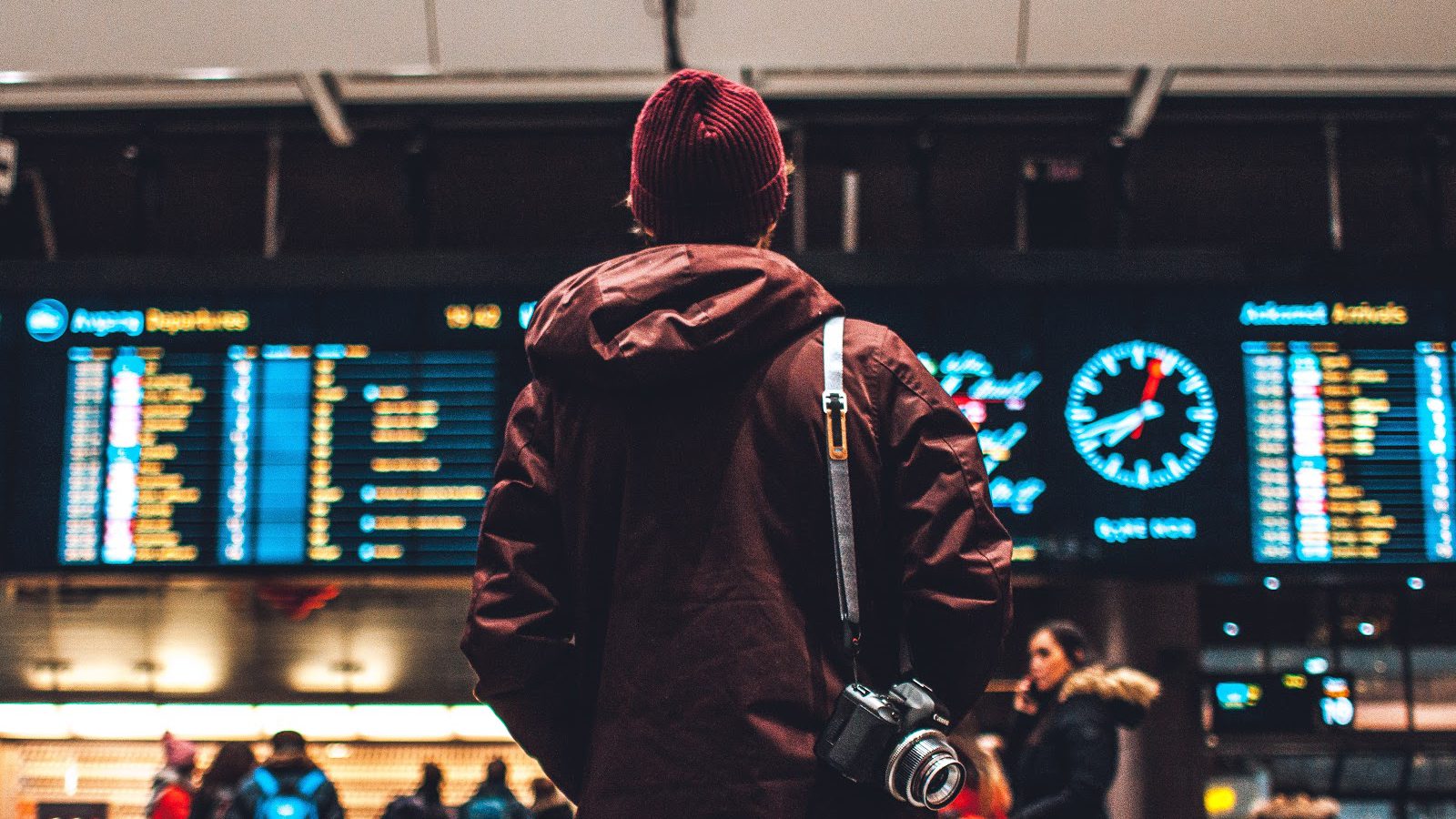 man staring at time table board