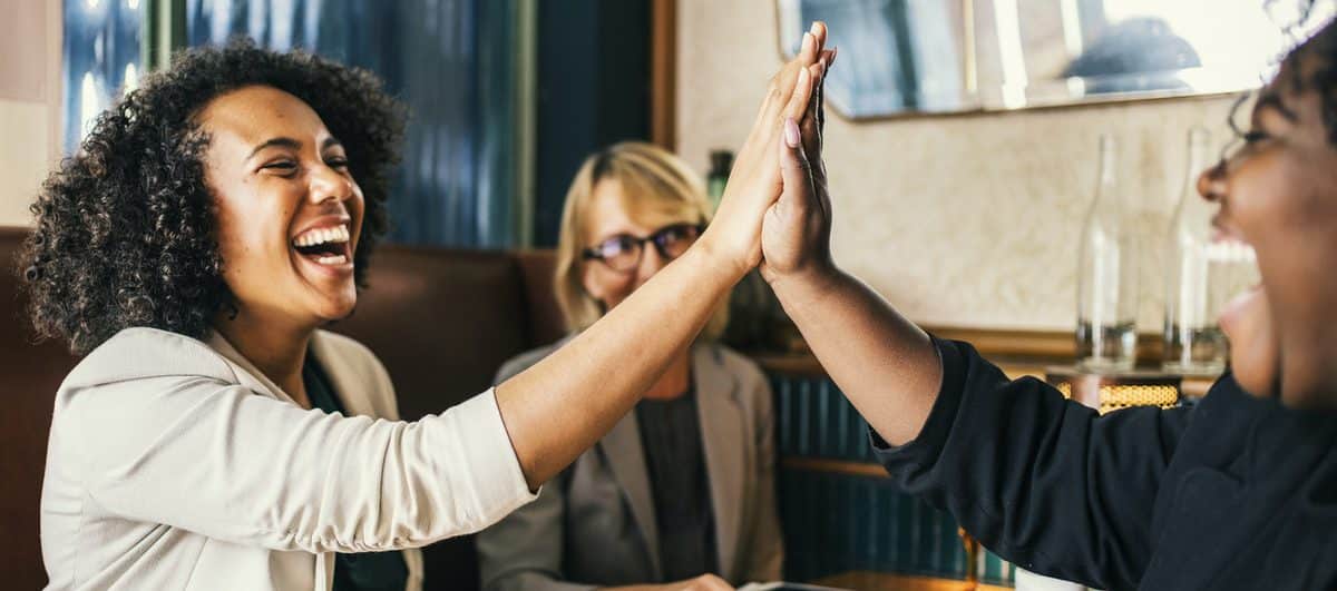 women giving high fives