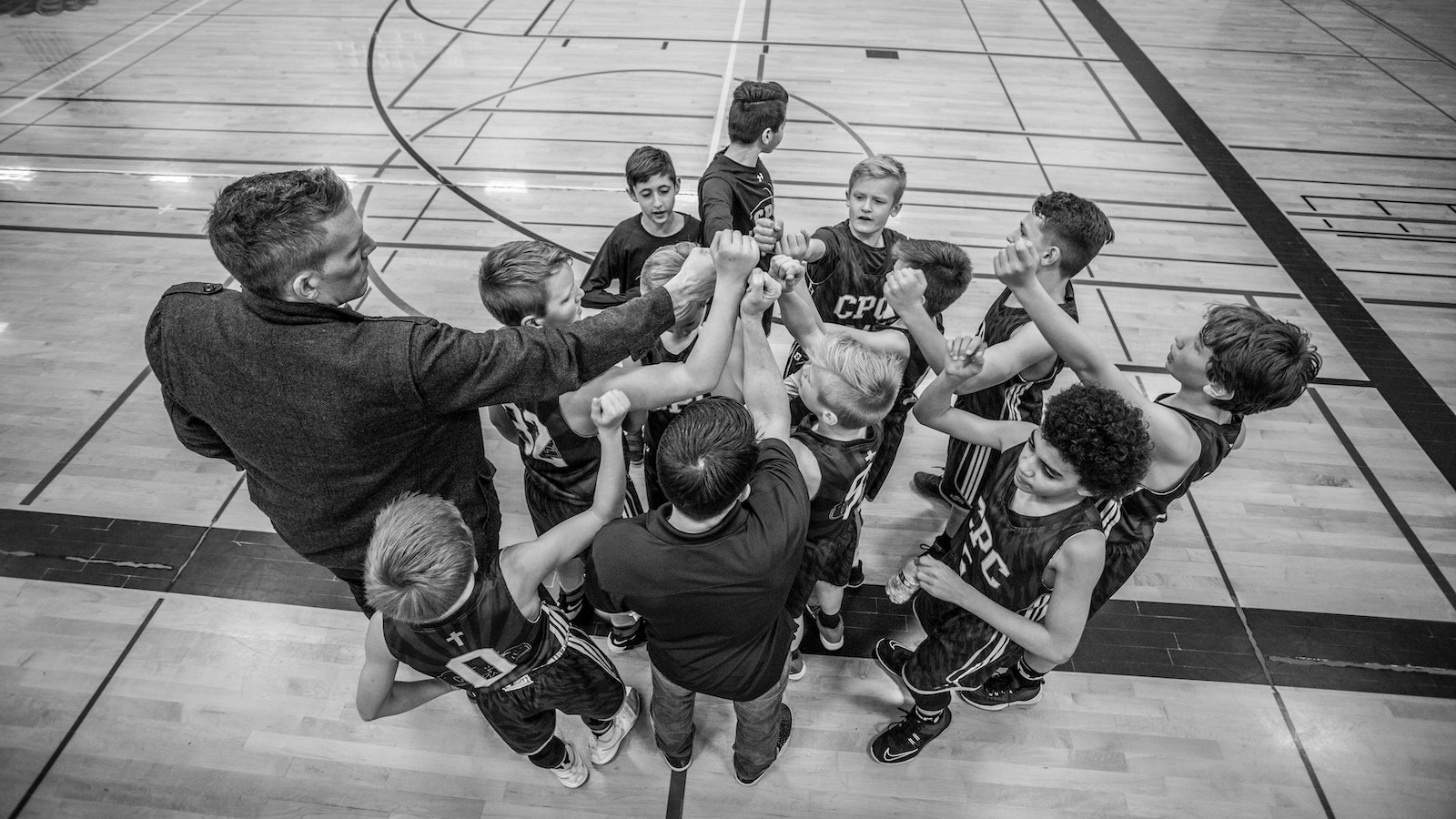 coach with team in huddle
